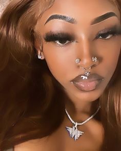 a woman with piercings on her nose and chest