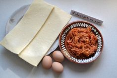 some eggs are sitting on a plate next to two pieces of cheese and another piece of bread