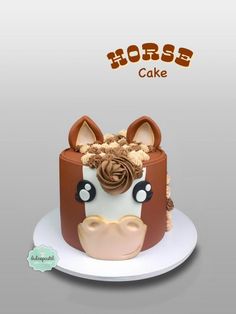 a horse cake with chocolate frosting and ears on it's head is sitting on a plate