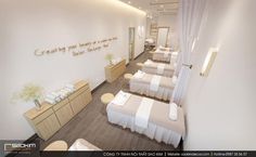 the interior of a spa with white linens and wooden furniture, including two massage tables