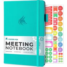 a blue notebook with stickers on the cover and a note book next to it