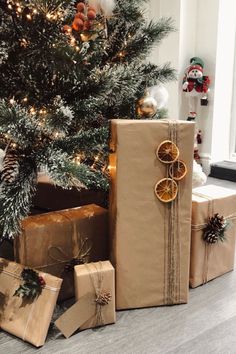 presents under the christmas tree are wrapped in brown paper