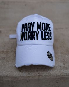 a white hat that says pray more worry less