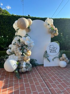 balloons and greenery decorate the entrance to an event