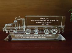 a clear glass trophy with a semi truck on it's side and the words your personalized here