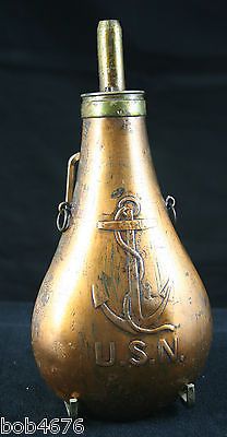 an old brass oil bottle with the word usn on it