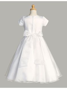 Gorgeous First Communion dress by Lito for your sweet girl. Short sleeve tea length style in white with round neckline satin bodice and crystal organza skirt. Features zipper closure and bow tie at the back. Whether your daughter is attending a communion, wedding, or other special event, this dress is the perfect choice for a truly unforgettable look. And if you have a younger daughter who also needs a dress, be sure to check out our original Lito Girls White Short Sleeve Crystal Organza Communi Girls First Communion Dresses, Communion Wedding, Girls Communion Dresses, Girls Short Dresses, Baptism Gown, Off Shoulder Gown, First Communion Dress, Organza Skirt, First Communion Dresses