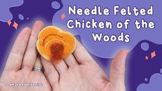 a hand holding a felted chicken of the woods brooch in it's palm