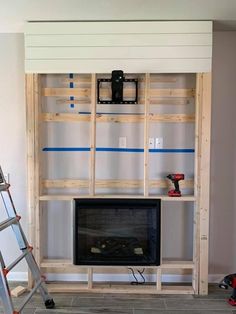 a living room with a fireplace and ladders