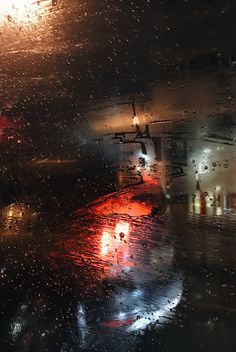 rain is falling on the windshield of a car