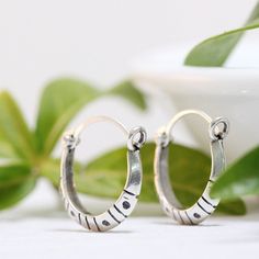 "These delicate, handmade Dots And Dashes hoops are the sort of earrings that you will never want to take off. They are simple yet striking, and very light weight. They measure just over 1/2\" wide by 5/8\" tall. Their clean lines are broken only by the lines and dots that are incised into them. They are given a black patina and then finished to a beautiful glow. The sterling ear wire is hinged on one side and clips neatly into a loop for maximum security. I will ship your order within 3-5 days Simple Hoop Earrings, Handmade Gifts For Her, Huggie Hoop Earrings, Round Earrings, Silver Hoops, Silver Hoop Earrings, Handmade Silver, Sterling Silver Earrings, Silver Earrings