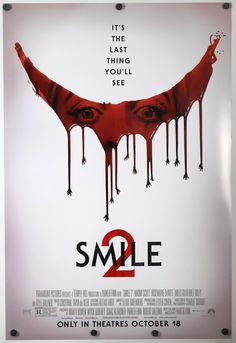 a movie poster with the words smile on it's face and blood dripping from its mouth