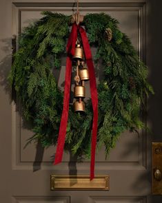 a christmas wreath with bells hanging from it