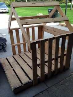 a wooden dog house made out of pallets on the sidewalk with an instagram post about it