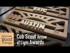 wooden name plaques with the words cub scout arrow of light awards