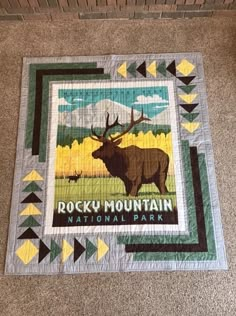 a quilt with the words rocky mountain national park on it and an image of a moose