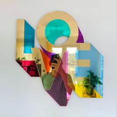 a man taking a selfie with his cell phone in front of a colorful mirror