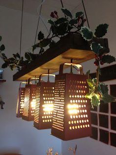 some lights are hanging from the ceiling in front of potted plants and other items