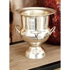 a large metal bowl sitting on top of a wooden table