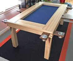 a wooden table sitting on top of a carpeted floor