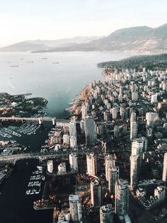 an aerial view of a large city next to the ocean