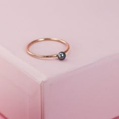 These tiny pearl stacking rings are perfect for a bit of regal glow or for taking your ring stack to the next level. They feature genuine lovely 3mm pearls which sit on a simple silver or gold filled band. They are post set, so the stone is stable and can withstand regular wear. Reliable and effortless - exactly the kind of sparkle that I love to add to my day. They're made from solid sterling silver or high quality 14K gold filled. The simplest way to elevate any look. (Let's be clear, though. While this ring can withstand regular wear and tear, this is a genuine pearl, which is still a relatively soft substance, so go easy on your ring if you want your pearl to keep its luster). Pearl Stacking Ring, Silver Stacking Rings, Gold Ring Stack, Rose Gold Band, Black Mini, Stone Design, Stacking Rings, Gold Bands, Gold Filled