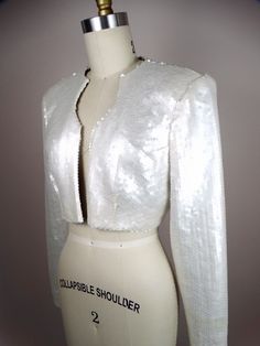 "This is a gorgeous couture vintage bolero jacket fully embellished with pearlescent ivory sequins. It's in perfect condition! Very well made! There are no closures, so measurements are taken with the front brought together. Bust - 36/38\" Shoulders - 16\" Sleeves - 24\" Length - 14\" Tag Size - 8 All of my items come from a smoke-free and pet-free home. If you have any questions, please don't hesitate to ask!" Embellished Fitted Party Outerwear, Fitted Embellished Outerwear For Party, Fitted Embellished Party Outerwear, White Fitted Glamorous Outerwear, Glamorous Fitted White Outerwear, Elegant Fitted Hand-embellished Outerwear, Elegant Fitted Hand Embellished Outerwear, Glamorous White Evening Outerwear, Fall Embellished Fitted Sequin Fabric