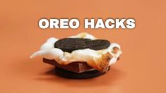 an oreo sandwich with marshmallows and cream on it is shown in front of the words oreo hacks