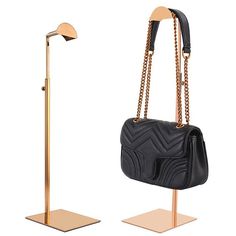 a black handbag on a stand with a gold base and an adjustable floor lamp