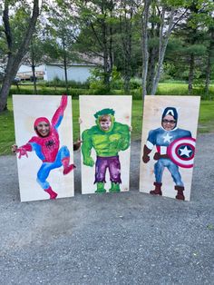 three children are holding up their paintings in the shape of superheros