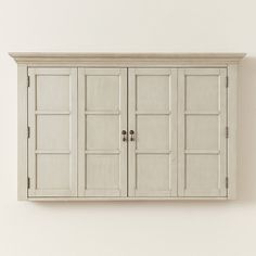 a white cabinet with three doors and two drawers