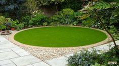 a circular lawn area in the middle of a garden