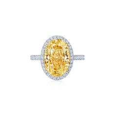 a fancy yellow diamond ring set in 18k white gold