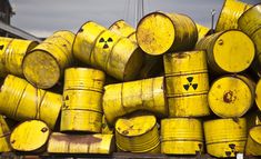 yellow barrels stacked on top of each other in front of a sign that says, when you failed science class, but you don't care because you can't care because you just found hundreds of barrels full of