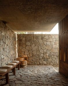 the inside of a stone building with benches