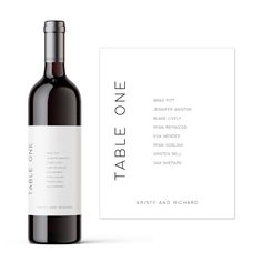 a bottle of wine next to a business card on a white background with the words table one printed on it