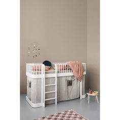 a child's bedroom with a white bunk bed and storage bins on the side