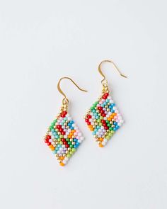 Add a little fun to your jewelry box! The Beaded Confetti Earrings are hand strung by Vi Bella Artisans in Haiti. Colors will vary. Choose from two sizes. Details: Handbeaded by Vi Bella Artisans in Haiti Small - 1 1/4" drop. Large - 1 5/8" drop. Multi-color pattern will vary. Summer Tiny Beaded Drop Earrings, Bohemian Summer Tiny Beads Beaded Earrings, Fun Multicolor Beaded Earrings, Confetti Beaded Earrings, Multicolor Tiny Beads Dangle Earrings, Confetti Earrings, Bracelets Handmade Diy, Large Earrings, Hand Beading