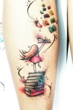 a woman's thigh with a tattoo on it and books flying from her legs