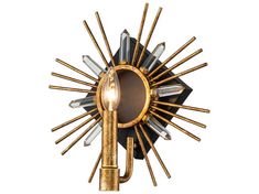 a gold and black wall light with a bulb on it's side, in the shape of a sunburst