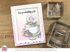 a card with a cake on it next to some cutters and stamping supplies