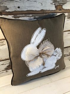 a decorative pillow with an image of a rabbit on it