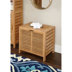 a wooden cabinet sitting in front of a mirror on top of a floor next to a rug