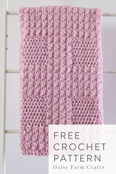 a pink crochet blanket hanging from a white ladder with text overlay that says free crochet pattern daisy farm crafts