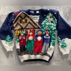 an ugly sweater is hanging on the wall in front of a house with santa claus and other people