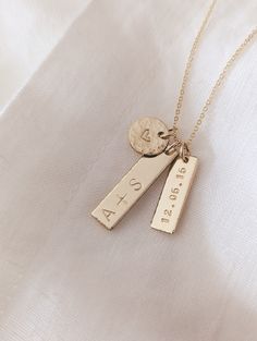 "Custom Vertical Bar Necklace, 14k Gold Filled, Sterling Silver, Personalized Initials Gold Bar Necklace, Heart Jewelry, Valentines Day Gift for Her, Anniversary Gift for Wife, Date Necklace D E T A I L S * Gold Filled: Gold Filled Disc, Clasp and Chain. * Sterling: .925 Sterling Silver Disc, Clasp and Chain. P E N D A N T * 3/8\" Heart Disc (Hammered) * Initial Bar: 1\" x 1/4\" (Hammered Edge) * Date Bar: 3/4\" x 1/4\" - 8 characters max including dots separating date (Hammered Edge) * Comes wi Date Necklace, Jewelry Personalized, T Bar Necklace, Metal Stamping Jewelry, Metal Stamping Jewelry Ideas, Engraving Ideas Jewelry, Mothers Day Jewelry, 3 Year Anniversary Gift Ideas For Him, Personalized Pendant Necklace