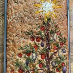 a christmas tree made out of bread on top of a wooden table next to a knife