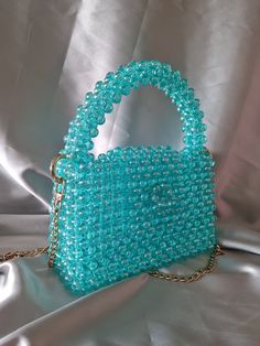 The bag is a great gift for yourself, a friend or mom This luxurious beaded bag is handmade without glue.  The bag is a bright turquoise color and has a beautiful shimmer in the sun with golden highlights.  !Product color may vary depending on screen settings.! Bead size 10 mm In the work, a strong fishing line 0.8 mm was used that can withstand a weight of 10 kg It has a detachable stainless steel chain strap. gold colored hardware. button on the lid of the bag.  chain length 120 cm bag size: l Gift Bag Birthday, Turquoise Bag, Bead Accessories, Black And White Bags, Hand Beaded Bag, Golden Highlights, Glitter Bag, Bags Ideas, Birthday Bag