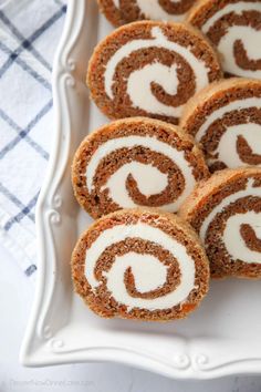 several cinnamon rolls on a white platter