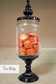 a glass jar filled with chocolates on top of a counter